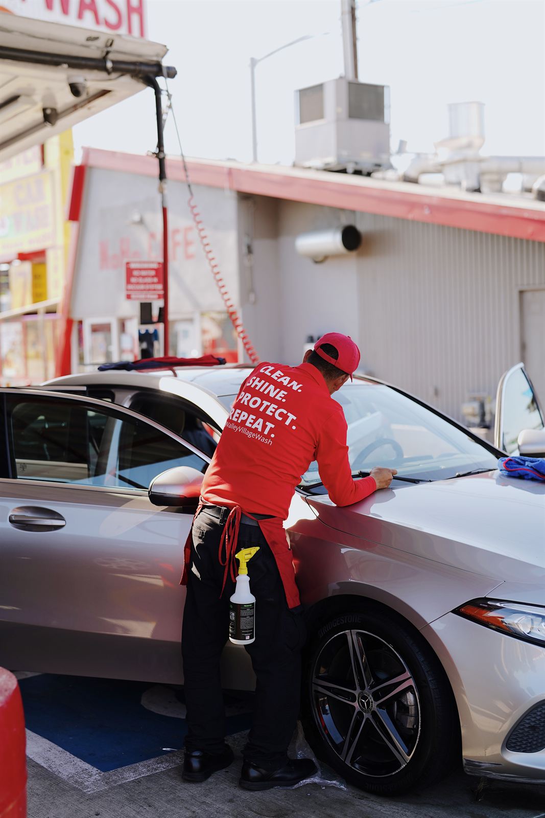 Detail team polishing a Mercedes at the Laurel Canyon Car Wash